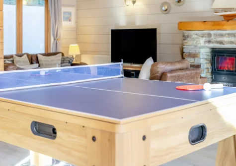 The living room, with multipurpose games table, at Honeywood, Little Petherick