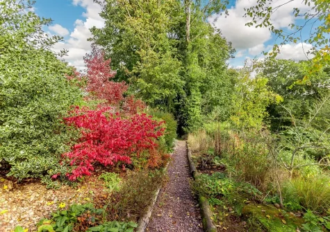Roam throughout the 10 acres of beautifully manicured gardens when you stay at Hopetown Cottage, Trescott