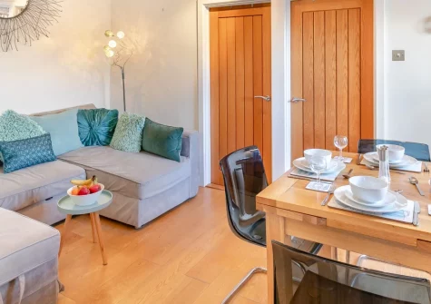 Horse Shoe, St Ives is a charming first-floor apartment in the heart of historic Downalong, featuring vaulted ceilings with exposed beams, contemporary coastal living, and an unbeatable location just moments from the harbour and Porthmeor Beach.