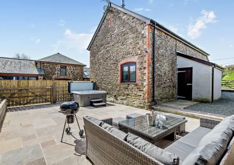 The patio, barbecue, outdoor sitting area & hot tub at Horslett Stable, Tetcott