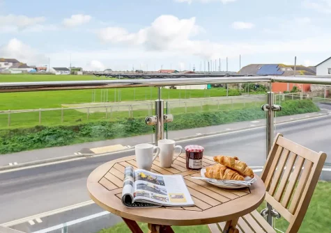The balcony & outdoor sitting area at Howzat Pavilion View, Westward Ho!