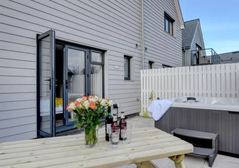 The patio, alfresco dining area & hot tub at Idle Hour, Westward Ho!