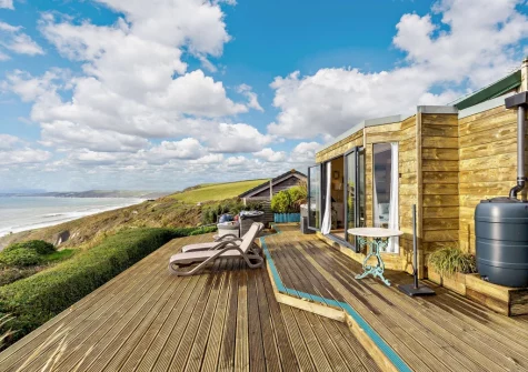 The decked terrace, with sun loungers, hot tub & outdoor sitting area, at Infinity, Freathy