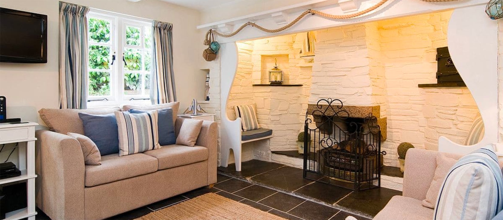 Inglenook Cottage is a two-bedroom cottage in Polperro with a welcoming inglenook fireplace. Furnished to a high standard it is ideal for cosy romantic breaks. Located in Crumplehorn, it has a pretty garden, furnished patio and allocated parking.