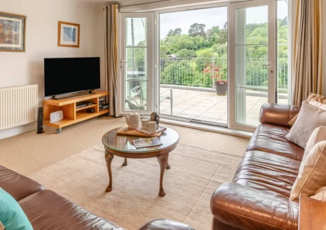 Inglewood Apartments, Kingswear is a bright two-bedroom retreat with panoramic River Dart views from a spacious terrace, contemporary interiors, and easy access to coastal paths, historic gardens, and the charming waterfront town of Dartmouth.