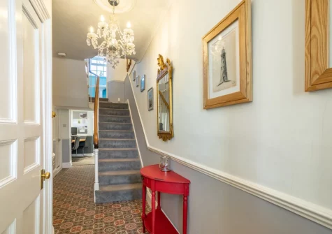The entrance hallway & stairs up to the first floor at Instow Cottage, Instow