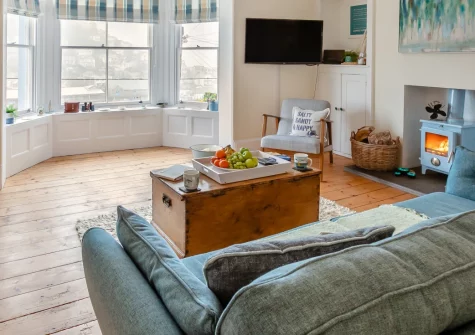 Inter-Nos, Looe is a spacious three-bedroom period home with great harbour views in the heart of this bustling coastal town, featuring elegant interiors with original features, a cosy wood burner, and Looe's sandy beach is a few hundred metres away.
