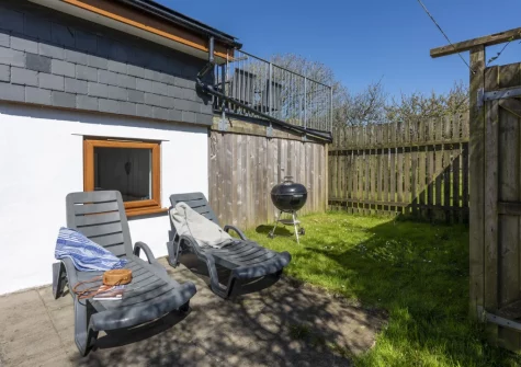 The patio, barbecue & outdoor sitting area at Ivy Chimney Cottage, Wheal Rose