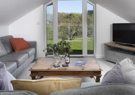 Ivy Chimney Cottage, Wheal Rose is a charming one-bedroom Cornish retreat with a furnished terrace overlooking mining heritage views, a cosy private courtyard garden, dog-friendly comfort, and easy access to Porthtowan's beaches nearby.