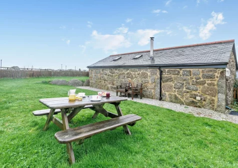 The enclosed garden, alfresco dining & sitting area at Ivy Cottage at Banns Farm, St Buryan