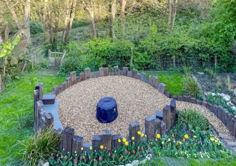 The enlosed garden with fire pit at Ivy Cottage, Boscastle