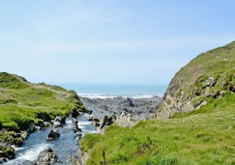 Nearby Welcombe Mouth Beach is a secluded, serene & rocky cove known for its dramatic cliffs, expansive rock pools, and popularity with experienced surfers