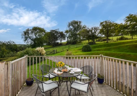The balcony & outdoor sitting area at Jasmine Cottage at Little Roseveth, Tregavethan