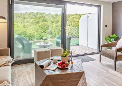 Jasmine, Looe is a sophisticated three-bedroom riverside retreat with panoramic views and private hot tub. Perfectly positioned for exploring Cornish beaches, it's ideal for families seeking modern comfort and traditional seaside magic.