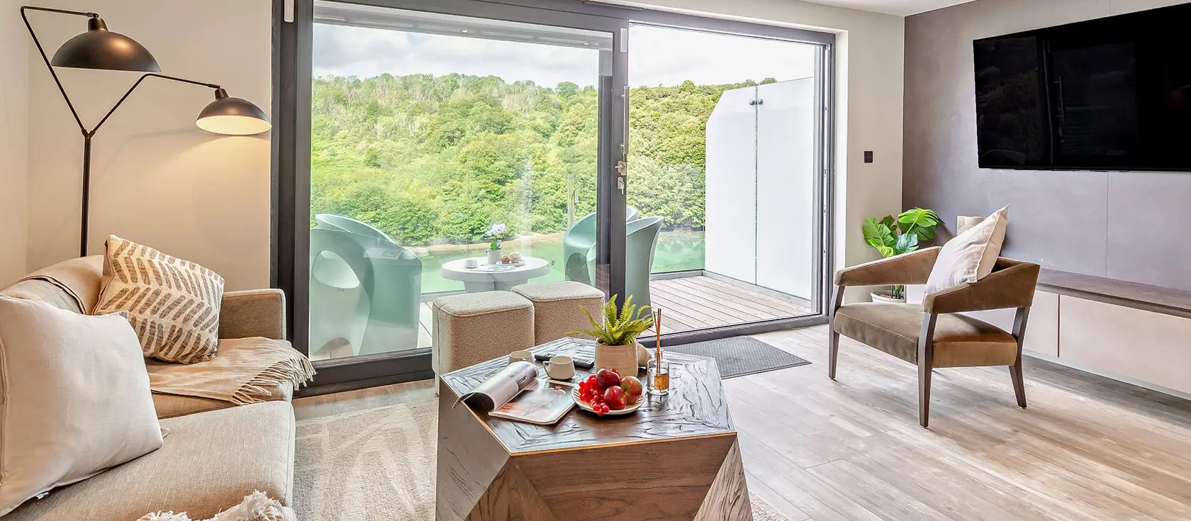 Jasmine, Looe is a sophisticated three-bedroom riverside retreat with panoramic views and private hot tub. Perfectly positioned for exploring Cornish beaches, it's ideal for families seeking modern comfort and traditional seaside magic.