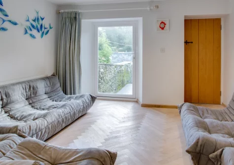 Jwala, Padstow is a welcoming three-bedroom townhouse in the heart of this harbour town, featuring a sunny south-facing garden, River Camel views from the top bedroom, and the beaches, shops, and waterfront all within easy walking distance.