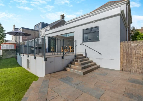 Steps down from the terrace lead you to the enclosed lawned garden