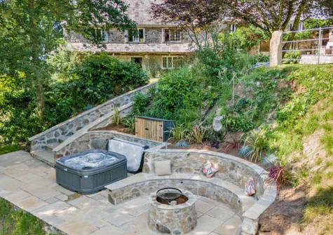 The lower patio, outdoor sitting area, firepit & hot tub at Kelly Mill Cottage, Lifton