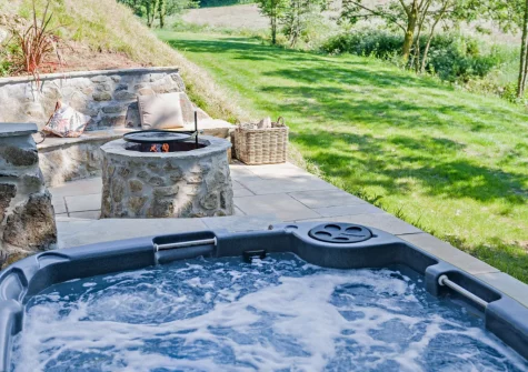 The lower patio, outdoor sitting area, firepit & hot tub at Kelly Mill Cottage, Lifton