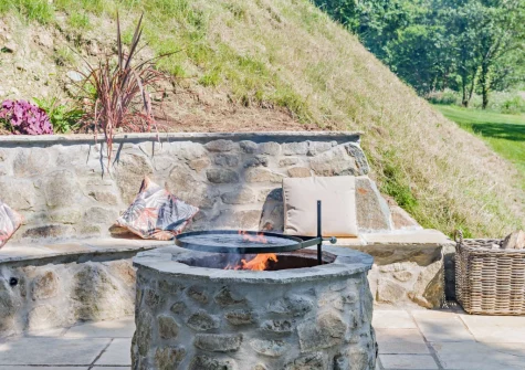 The lower patio, firepit & outdoor sitting area at Kelly Mill Cottage, Lifton