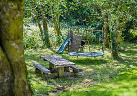 The garden with children's play equipment at Kelly Mill Cottage, Lifton