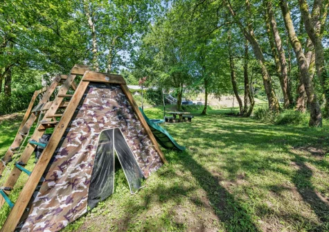 The garden with children's play equipment at Kelly Mill Cottage, Lifton