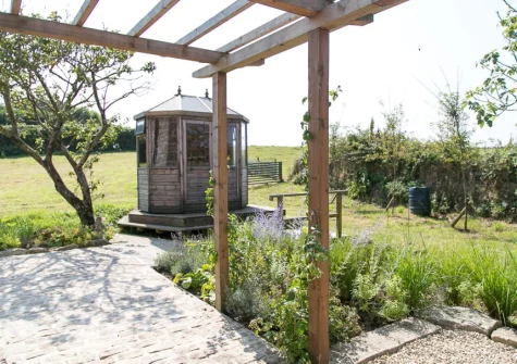 The patio, rotating summerhouse & lawned garden at Kemyel Mill, Lamorna