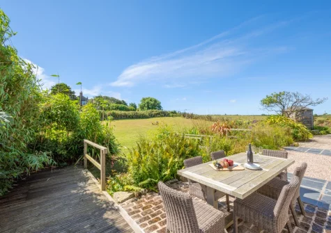 The patio, alfresco dining area & large lawned garden at Kemyel Mill, Lamorna