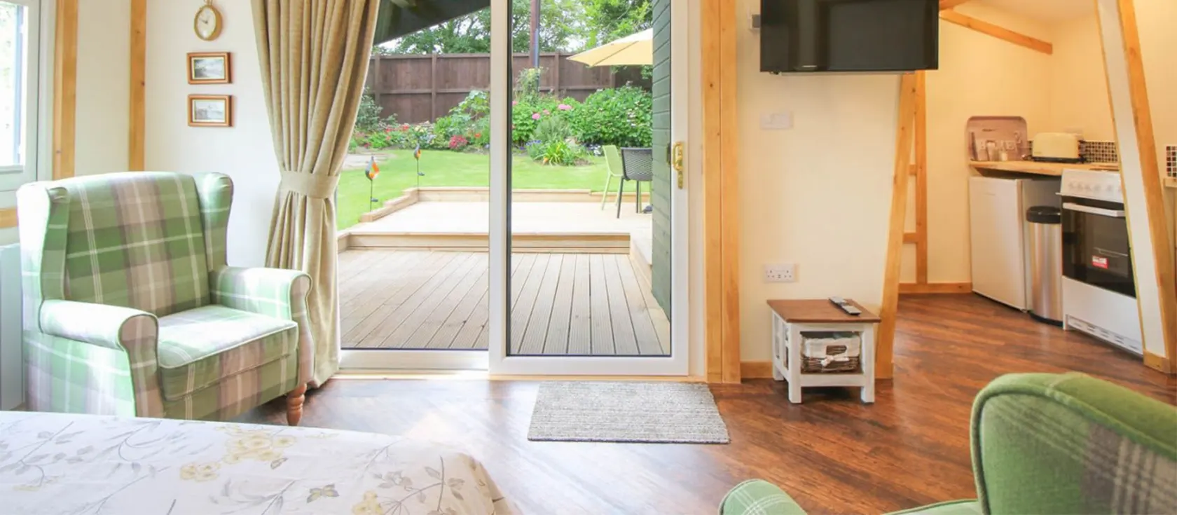 Kessenyans Studio, Goonhavern is a luxury studio for two with attractive living space, wood flooring, stained glass & ceiling beams. Neat kitchen area, modern bathroom and double bed. Patio doors frame the beautiful private gardens with deck & covered seat.