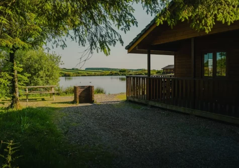 Enjoy lake views from the barbecue & alfresco dining area at Kestrel Lodge 15 at Clovelly Lakes, Higher Clovelly