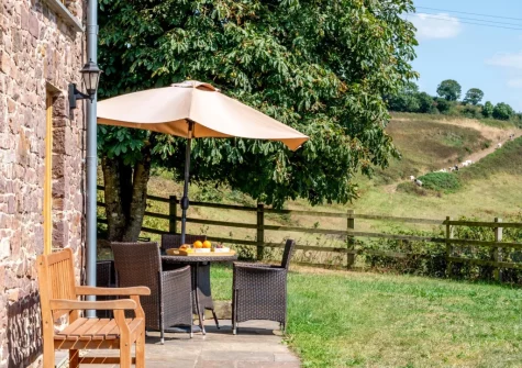 The patio, alfresco dining area & enclosed garden at Kingfisher Cottage, Coldridge