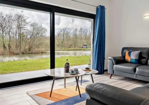 Kingfishers Retreat, Hopworthy is a contemporary 2-bedroom lakeside sanctuary with private hot tub and exclusive fishing lake. Enjoy modern interiors, stunning water views, and easy access to Bude's golden beaches and Devon's enchanting countryside.