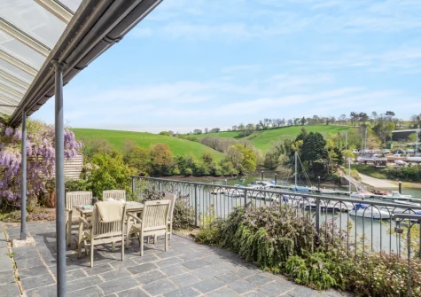The private riverside terrace & alfresco dining area at Kits House at Mixtow Creek, Lanteglos