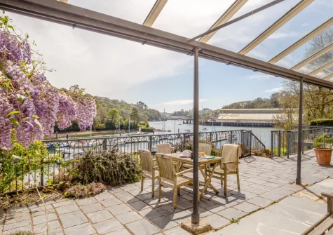 The private riverside terrace & alfresco dining area at Kits House at Mixtow Creek, Lanteglos