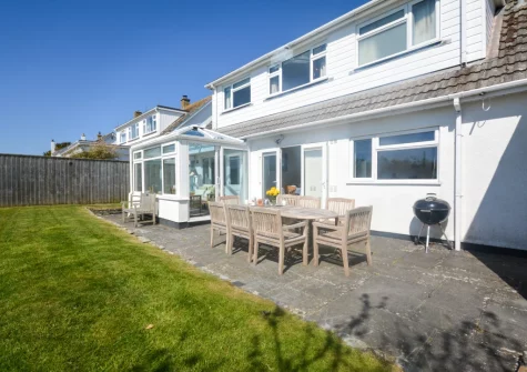 The patio, barbecue, alfresco dining area & enclosed lawned garden at Kittiwake, Constantine Bay