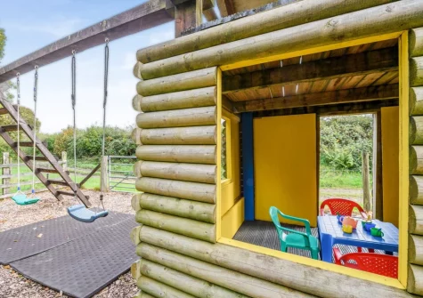 The enclosed children's play area at Knaworthy, Frithelstock Stone