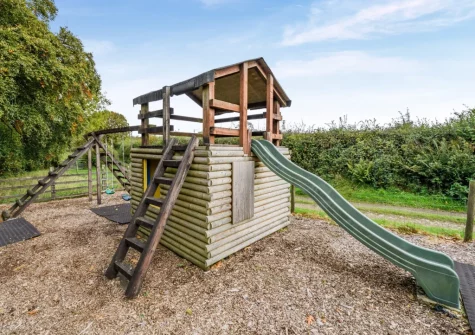 The enclosed children's play area at Knaworthy, Frithelstock Stone