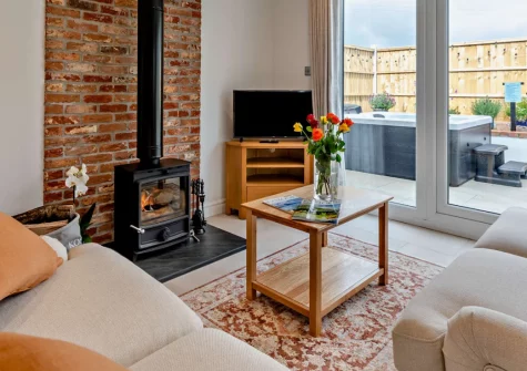 Kosi Kot, South Molton is a luxurious cottage on Exmoor's edge, featuring a private hot tub, cosy wood burner, contemporary interiors, and spectacular countryside setting perfect for romantic escapes and walking enthusiasts seeking tranquillity.