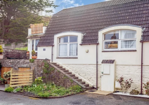 Lakenham Lodge is a 'upside down' courtyard cottage with elevated private patio-balcony