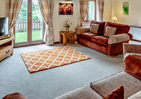 Lamerton Barn, Holsworthy is a charming barn conversion set within 150 acres of Devon countryside. Featuring four comfortable bedrooms, a spacious living area, a private hot tub, and access to a picturesque lake, it's perfect for a family holiday.