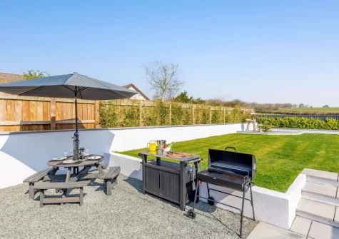 The patio, barbecue, alfresco dining area & enclosed garden at Lazy Acres, Pyworthy