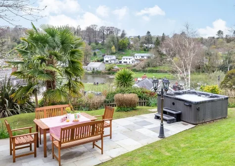 The patio, alfresco dining area & hot tub at Lerryn Cottage, Lostwithiel