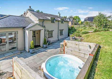 The patio, private hot tub & lawned garden at Lilyville at Higher Treyone, Hessenford