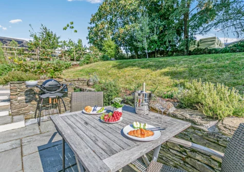 The patio, barbecue, alfresco dining area & lawned garden at Lilyville at Higher Treyone, Hessenford