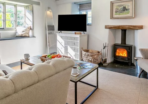 Lilyville at Higher Treyone, Hessenford is a beautifully renovated farm cottage in peaceful south-east Cornwall, featuring a private hot tub, cosy wood burner, and enclosed garden, with wild beaches and pretty harbour villages nearby.