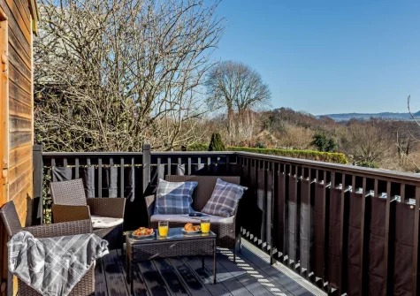 The decked terrace & outdoor sitting area at Little Ash Lodge, Fenny Bridges