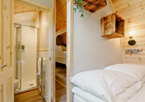 The king-size bed, small bunk & shower room at Little Cedar at Meldon Lodge Park, Meldon