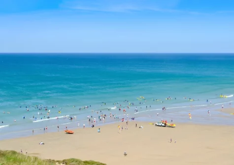 The Perranporth Beach is popular for surfing, dog walking & families, featuring the Watering Hole pub directly on the sand at Little Foxes, Perranporth