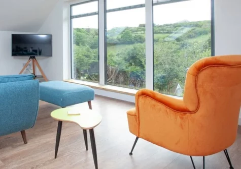 Little Foxes, Perranporth is a charming detached house set in peaceful countryside, boasting valley views from a raised garden terrace, contemporary interiors with open-plan living, and just a ten-minute stroll to Perranporth's golden sands.