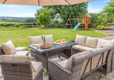 The alfresco dining area, garden & children's play area at Little Lower Pengelly, Blisland